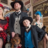 A family poses in old-time clothes.