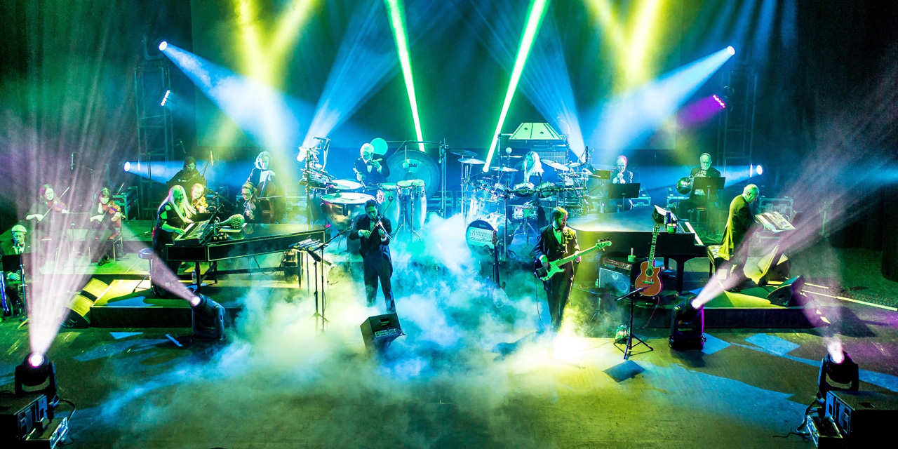 Orchestra performing with colorful light show at Crystal Grand.