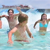 Family playing at a large wave pool at Mt. Olympus Water & Theme Park.