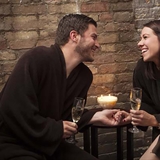 A couple relaxing with champagne at Spa Serenity.