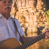 A man plays guitar for guests.