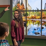 A family admires nature decorations.