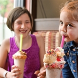 A family enjoying milkshakes.