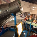 family in front of Mercury 2