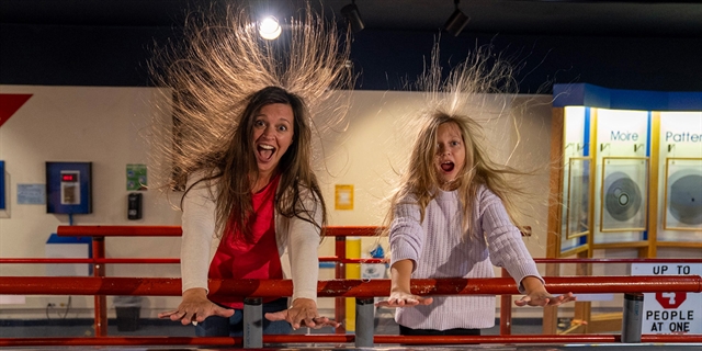 Mom and daughter try the Van De Graf Generator
