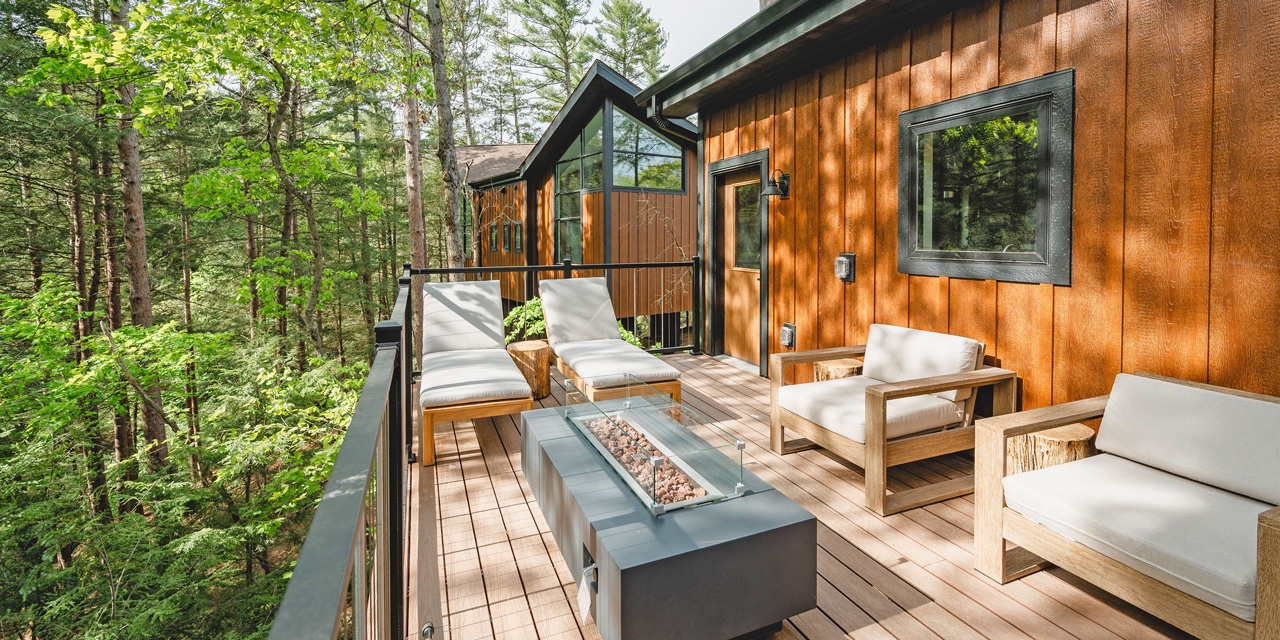 Large patio with seating and a large villa in the background.