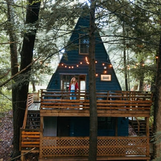 A woman stand on the deck of a vacation rental home in Wisconsin Dells.