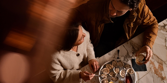 A couple dining at Redd's Piano Bar.