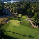 Gold course amid wooded forest.